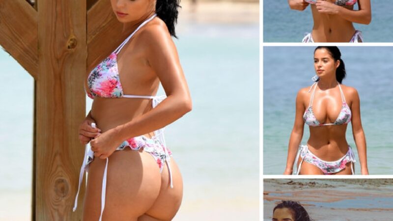 Demi Rose sunbathes in floral clothes on the beach